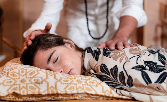 Woman receiving relaxing massage on a bed.