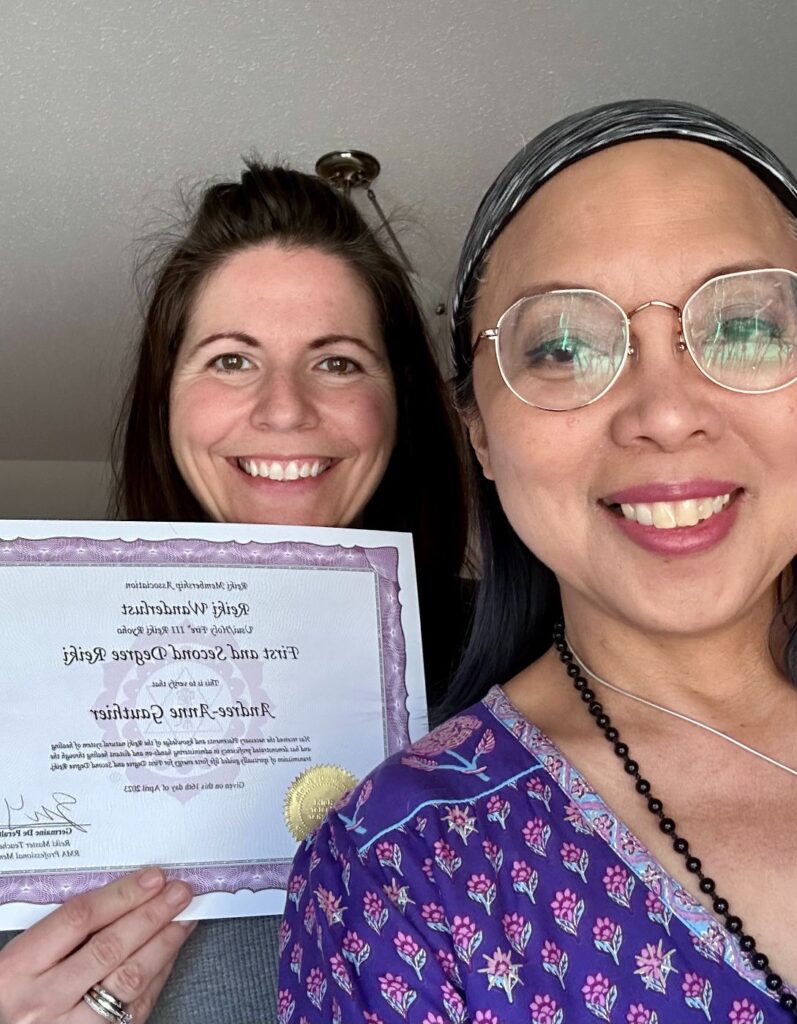 Two women posing for a photo holding a certificate.
